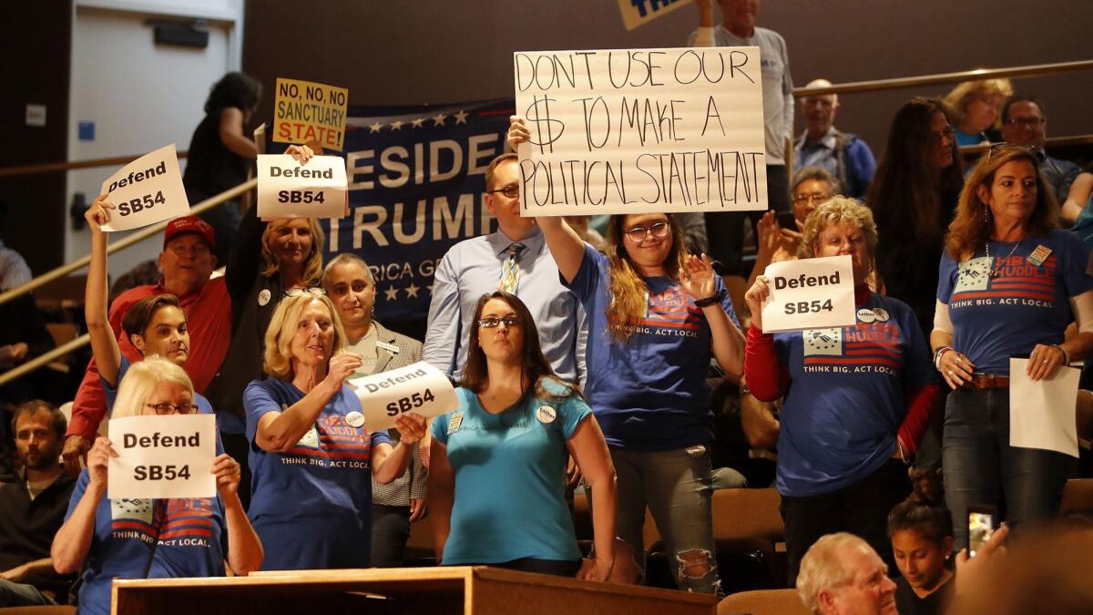 Supporters of Senate Bill 54, the California "sanctuary state" law, demonstrate during Monday's Huntington Beach City Council meeting.