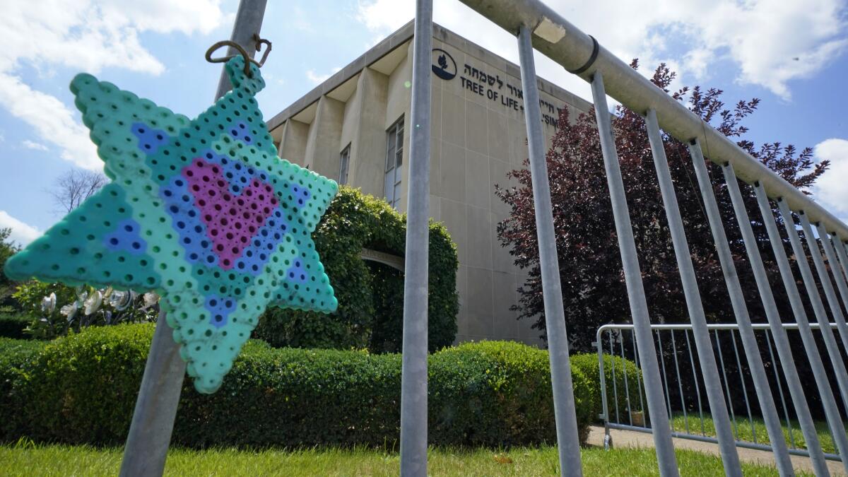 A Star of David hangs from a fence outside the dormant landmark Tree of Life synagogue in Pittsburgh.
