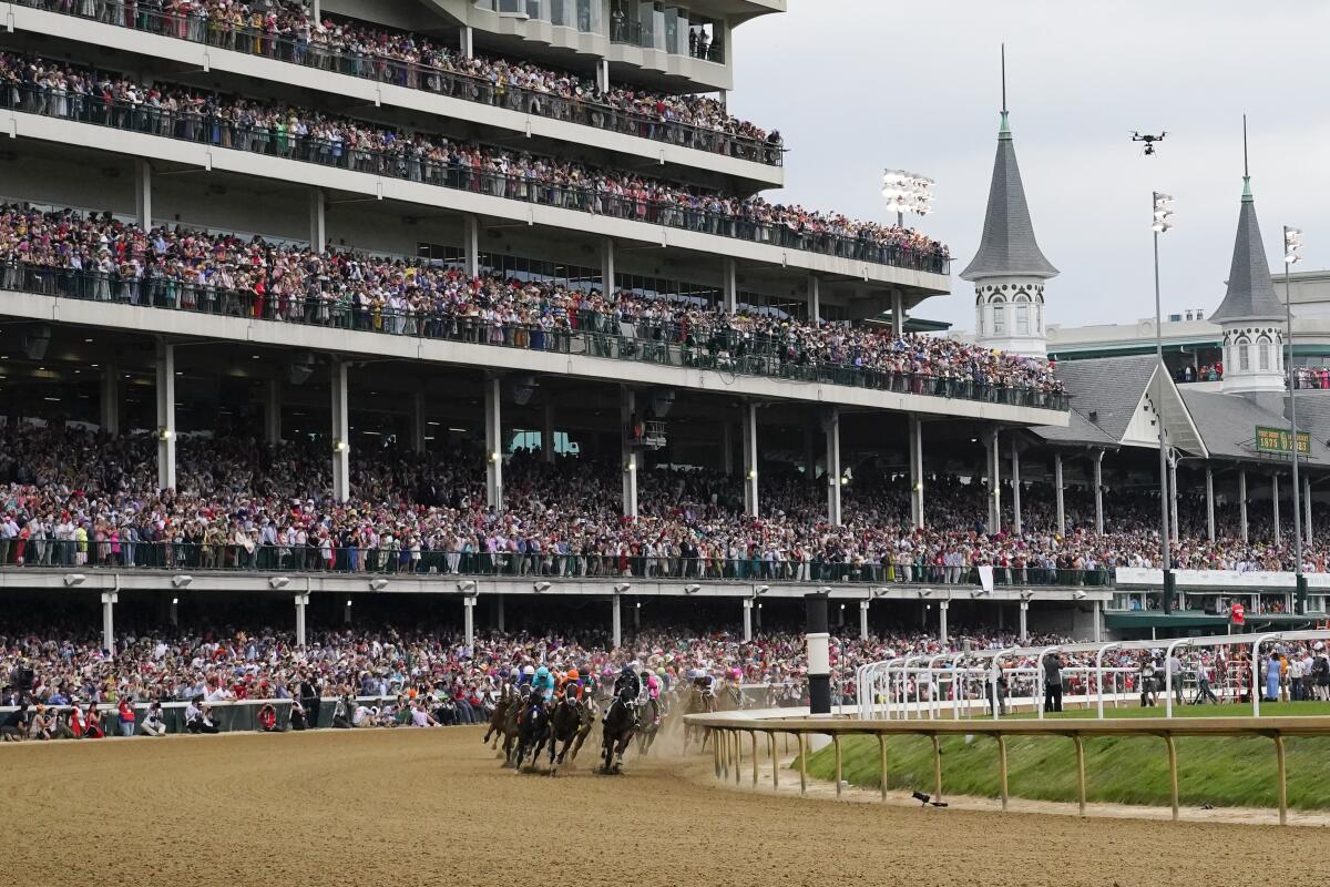 Horses make the first turn as they compete during the Kentucky Derby on May 6, 2023, at Churchill Downs in Louisville.