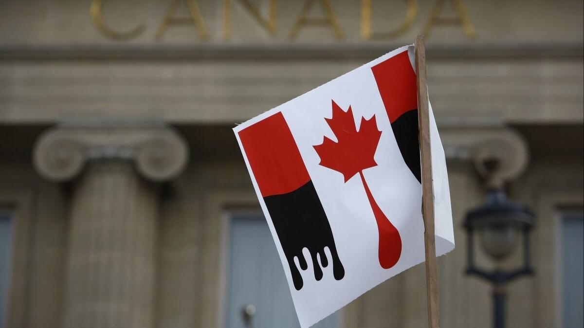 A flag protesting against the exploration of Canadian tar sands oil on Feb. 13, 2010.