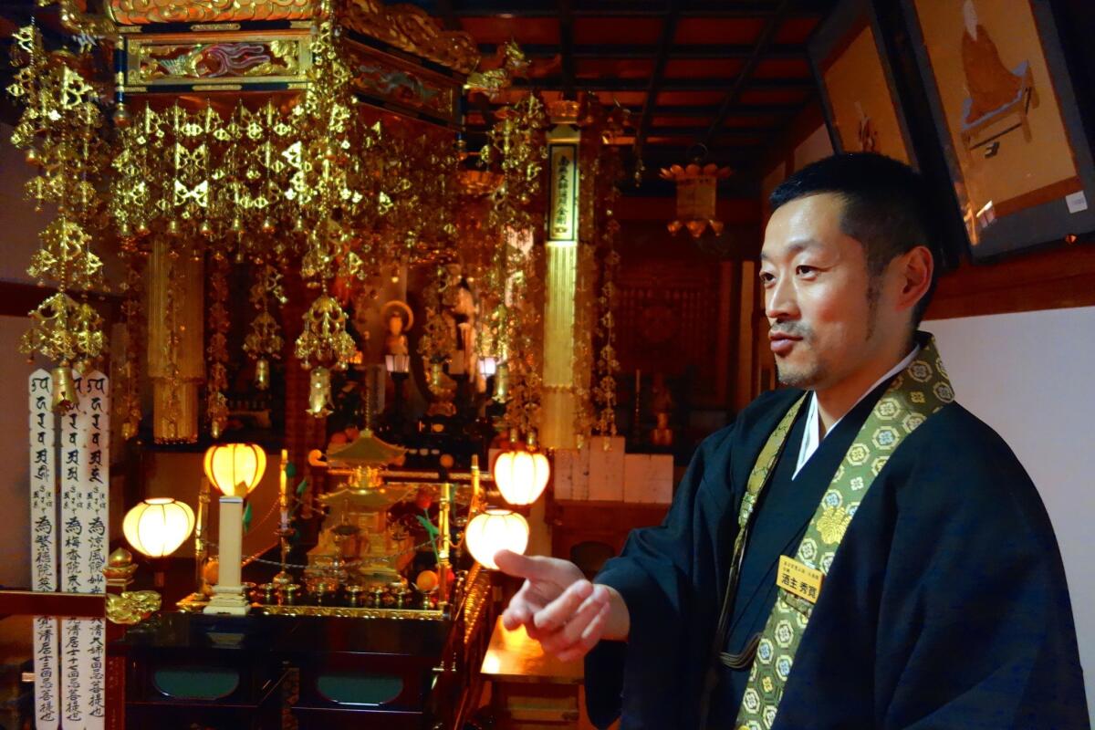 "In Japan, by remembering the dead, we honor the living. This town can come back," says Buddhist priest and city employee Shukan Sakanushi in Naraha, Japan.