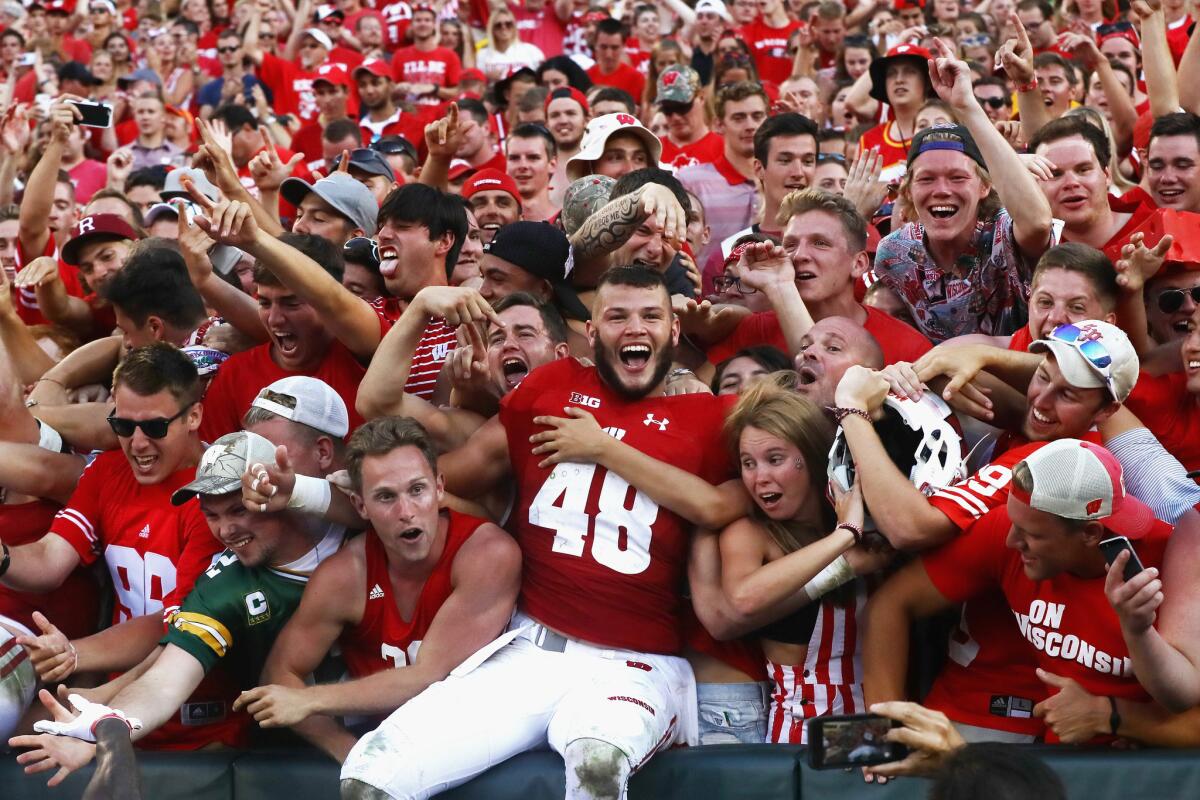 Wisconsin linebacker Jack Cichy (48) celebrates with fans after defeating the LSU Tigers, 16-14, at Lambeau Field on Sept. 3.