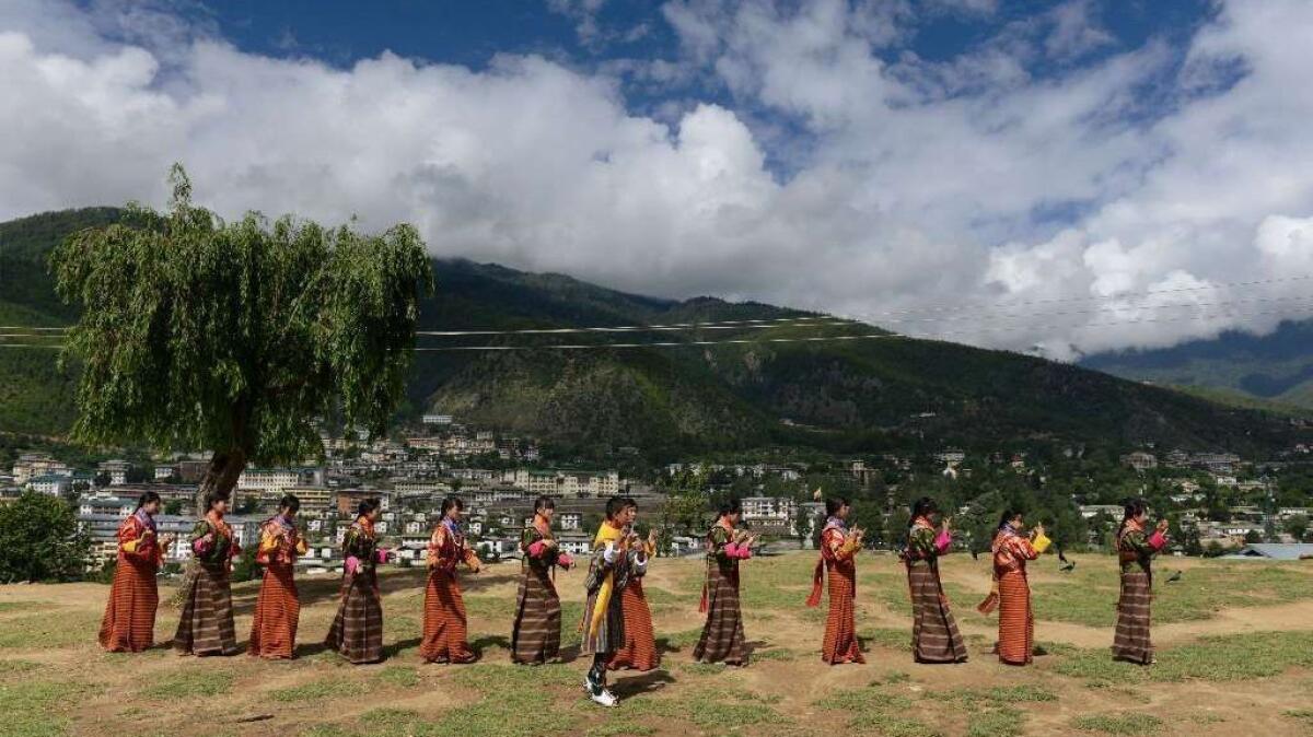 In this 2013 photo, Bhutanese teenagers practice before a cultural event to celebrate the birth of Bhutan's fourth king.