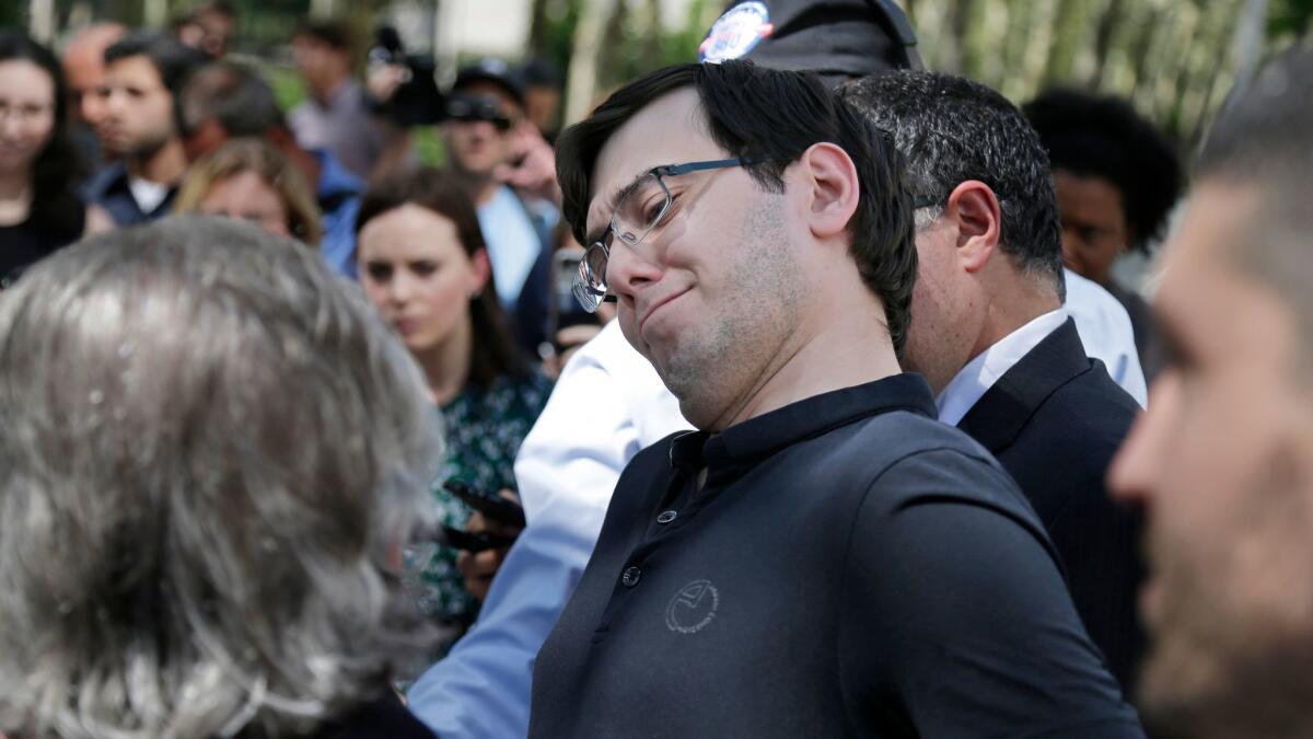 Martin Shkreli makes a face as his attorney Benjamin Brafman talks about his client's reputation while addressing reporters in New York on Aug. 4, 2017.