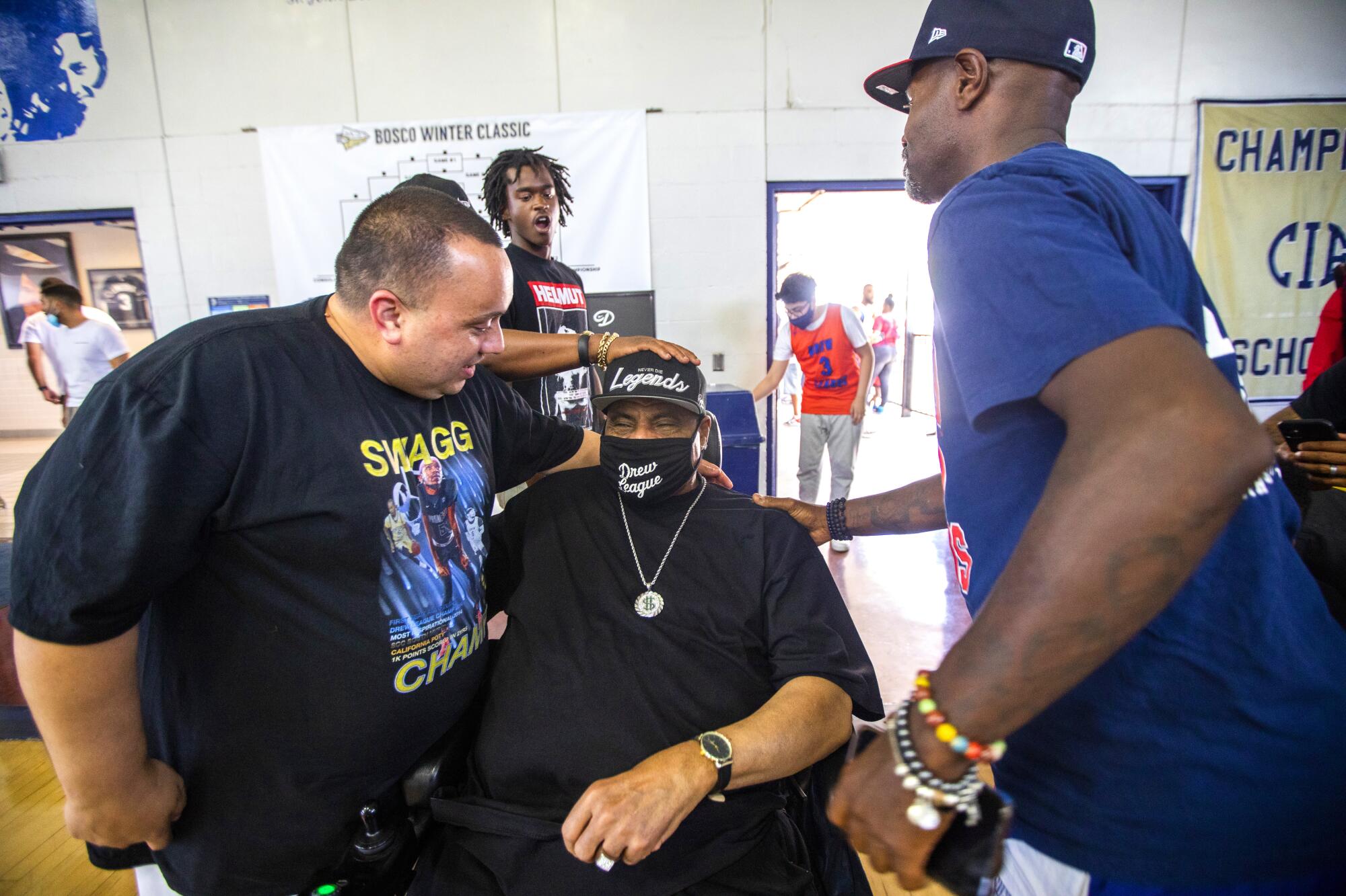 Bill Crawford is surrounded by friends at the Drew League opener this summer.