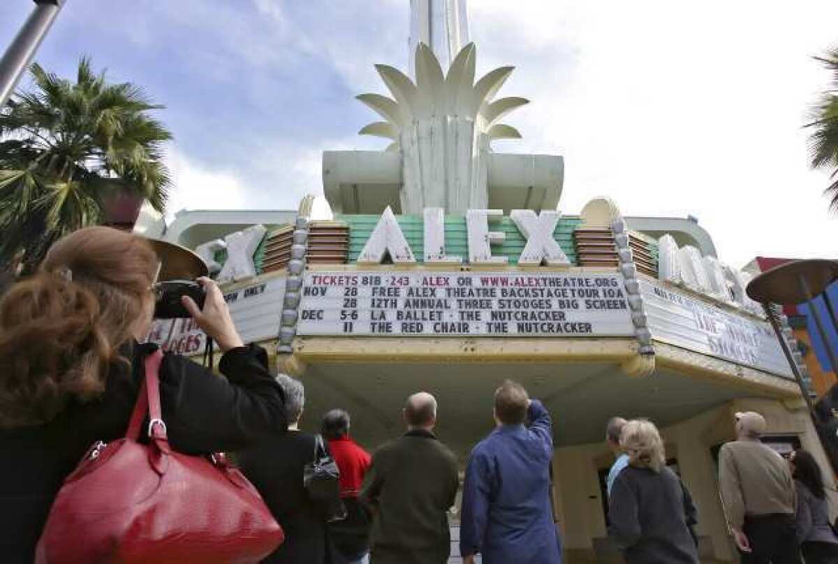 Visitors tour the Alex Theatre in Glendale in 2009. Because the historic structure might be sold, officials have put off renovations.