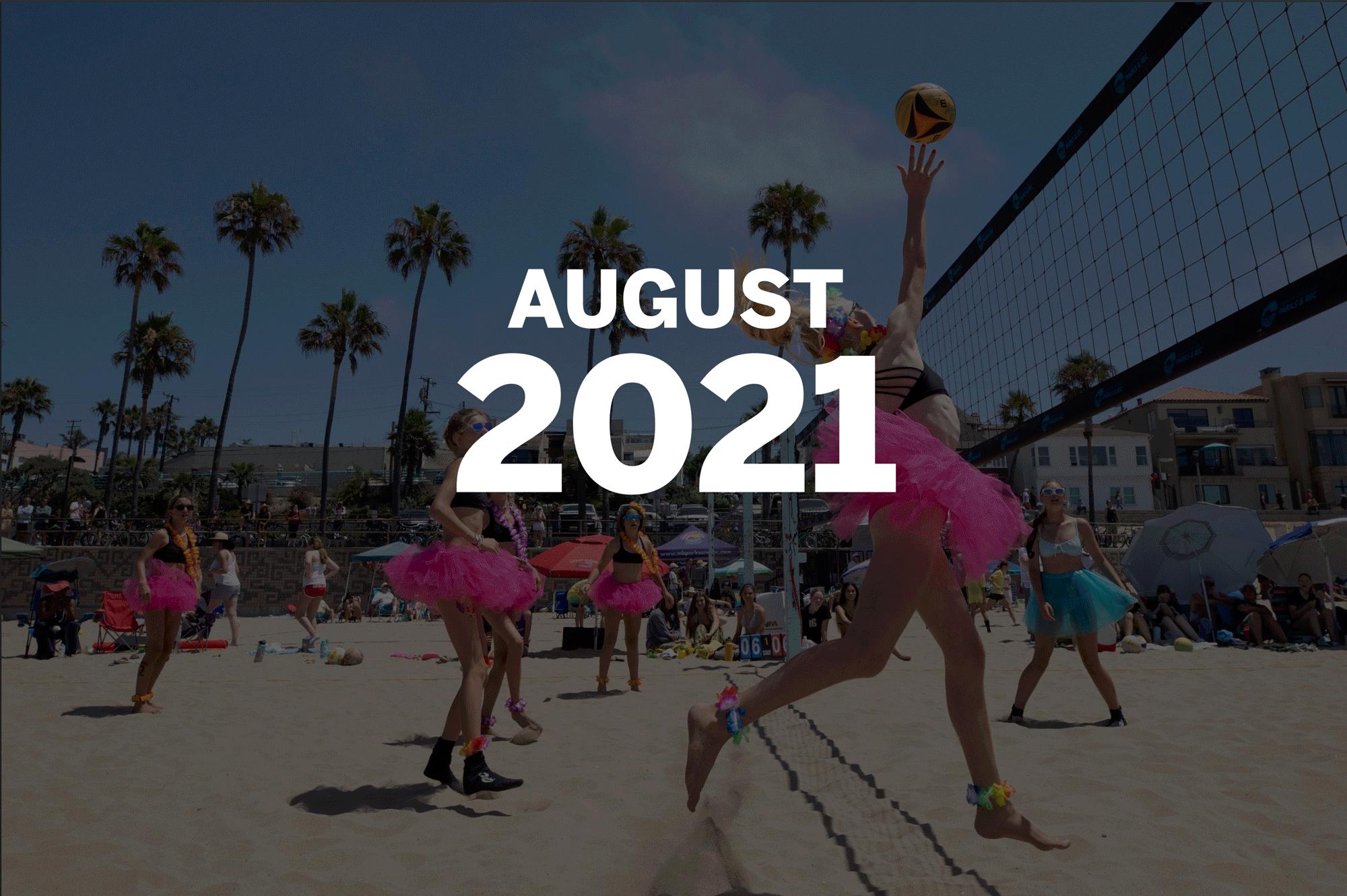 Aug. 1: Women in bright pink tutus play volleyball on the sand