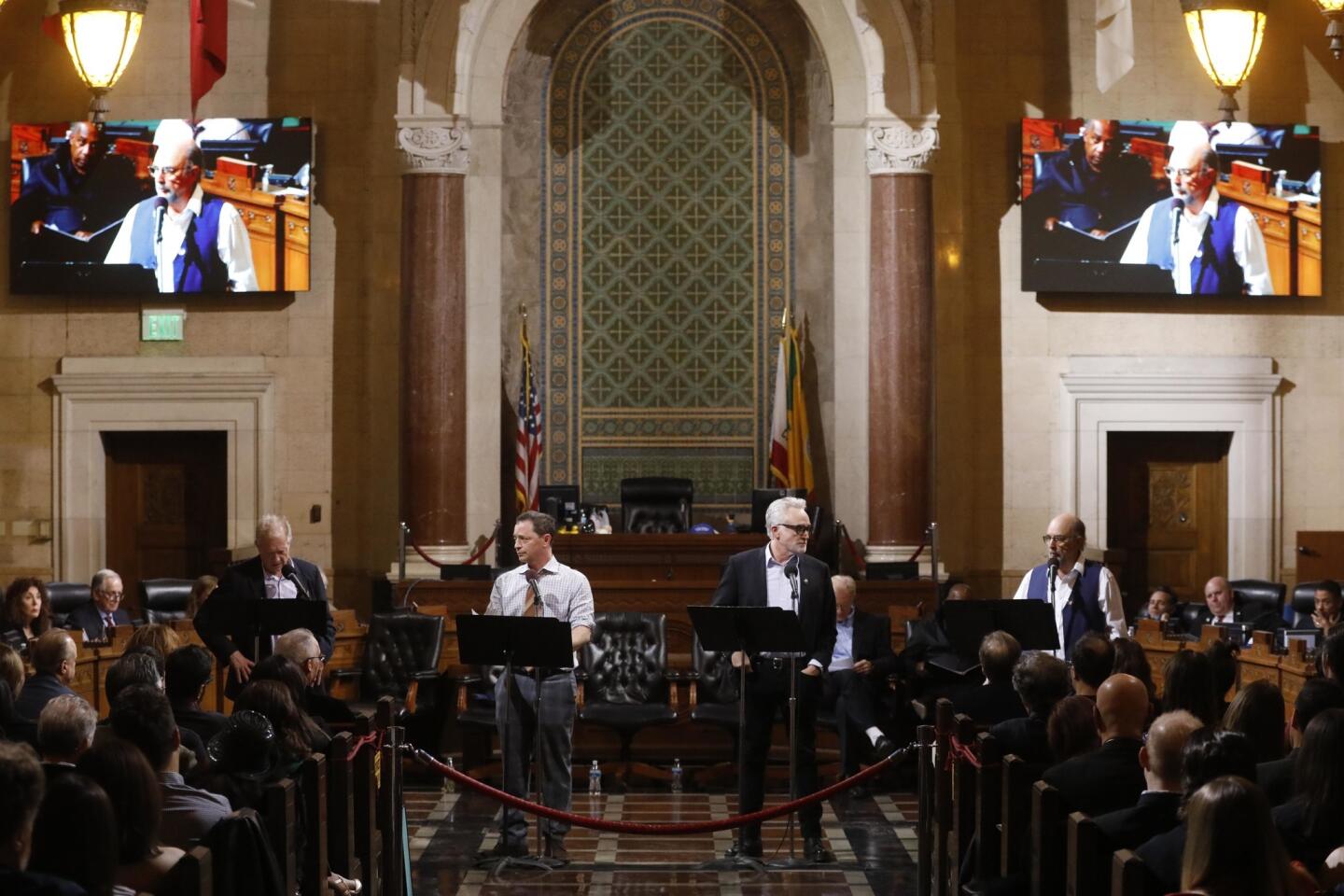 Actors Jeff Perry, left, Joshua Malina, Bradley Whitford and Richard Schiff perform in the Fountain Theatre's production of a one-night-only reading of the screenplay to "All the President's Men" in City Council Chambers in City Hall in Los Angeles on Jan. 27, 2018. The point was to celebrate a free press in an era when it's under attack by the White House. The Fountain's artistic director, Stephen Sachs, recruited an all-star cast that was essentially a "West Wing" reunion.