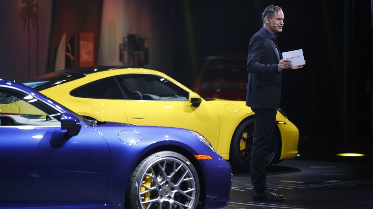 Porsche CEO Oliver Blume introduces 2020 Porsche 911 models during a news conference at the L.A. Auto Show on Wednesday.