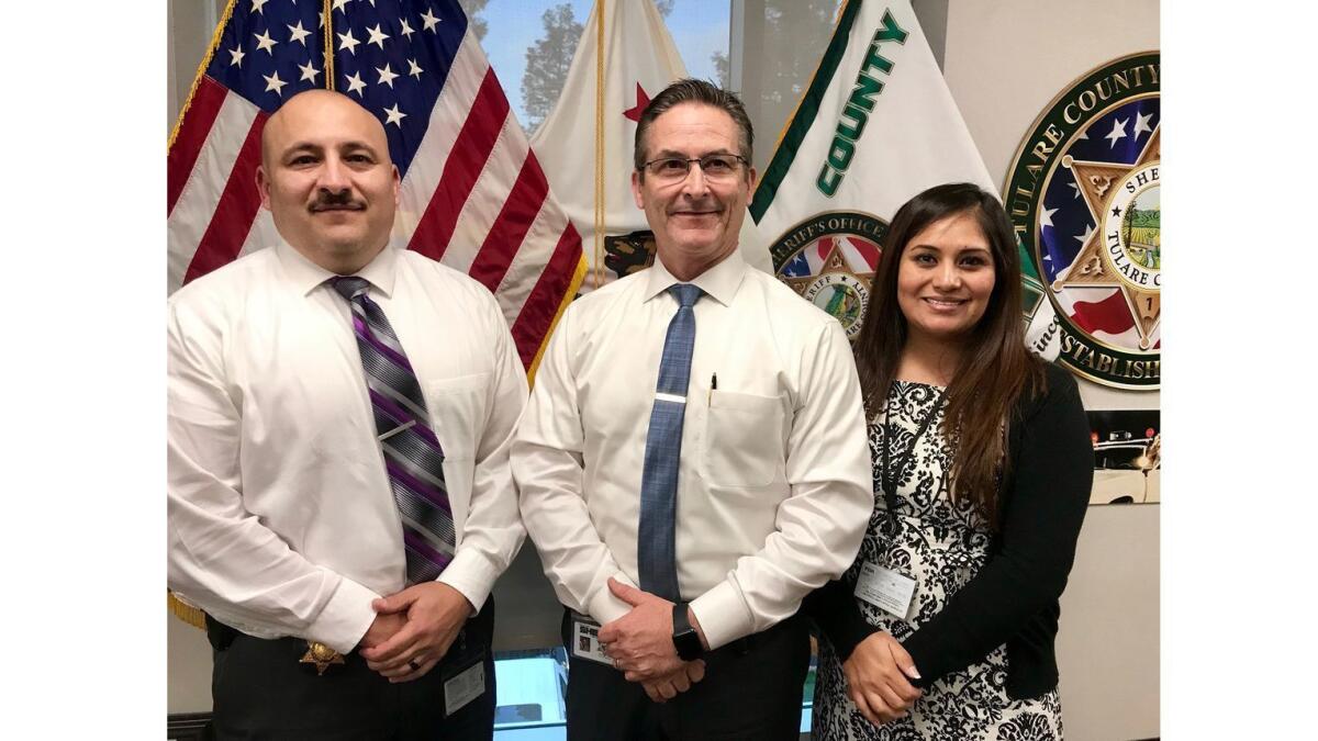 Tulare County Sheriff Mike Boudreaux flanked by Capt. Gabriel Macias and Deputy Monserrat Meza.