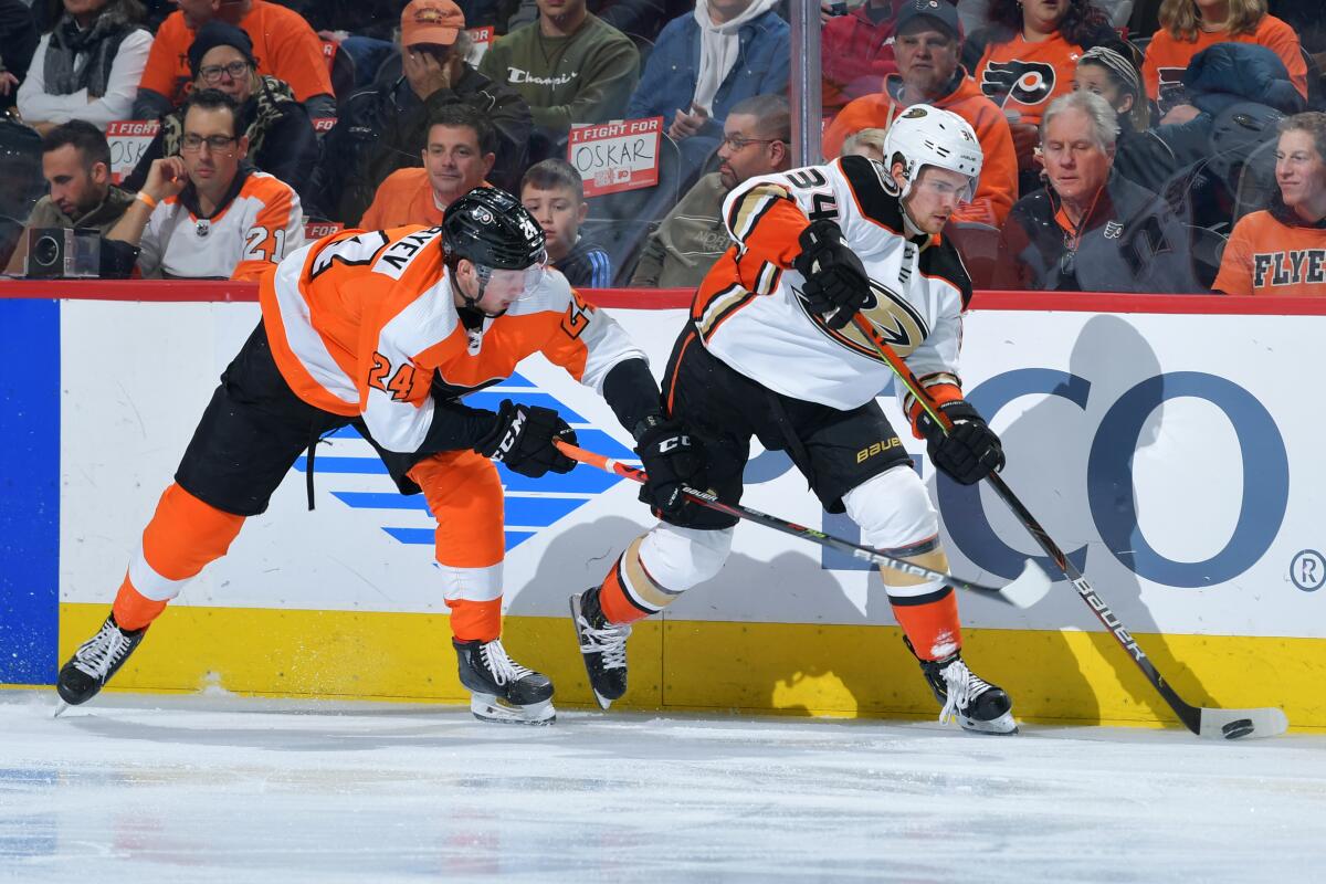 Ducks forward Sam Steel, right, looks to pass the puck in front of Philadelphia Flyers forward Mikhail Vorobyev during the third period of the Ducks' 4-1 loss Tuesday.
