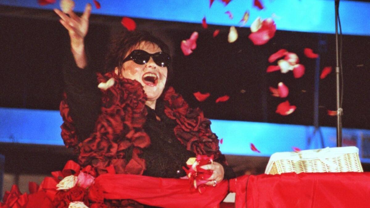 Barr tosses rose petals at the first taping of her talk show.