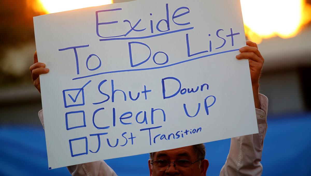 Community members and activists gather in a backyard of a home east of downtown Los Angeles to mark the closure of the Exide Tchnologies battery recycling plant on Thursday, Mar. 12, 2015.