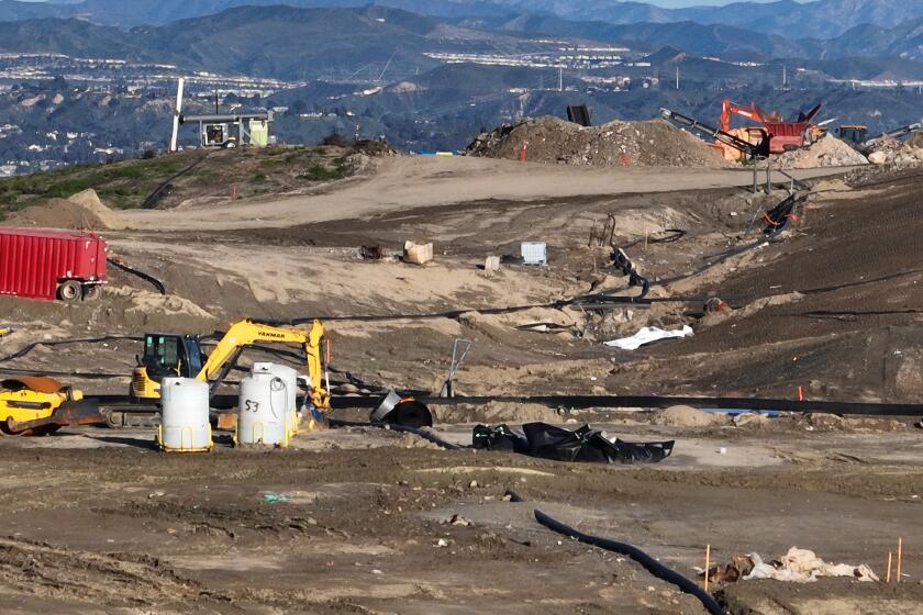 Castaic, CA - February 22: An aerial view of equipment where contaminated or polluted water is being extracted to fill roughly 100 metal storage containers, holding up to 20,000 gallons each as the result of an underground landfill fire at Chiquita Canyon Landfill in Castaic Thursday, Feb. 22, 2024. Around 200,000 gallons of the contaminated water is coming out of the landfill each day. Environmental regulators have found elevated levels of cancer causing Benzine in the polluted water spilling onto the surface of the landfill. Landfill operators are also constructing a drainage system to capture the contaminated water that is spilling onto the surface and proactively pumping the water. Residents of Val Verde and Castaic are protesting to call for Chiquita Canyon Landfill to be closed in Hasley Canyon Park in Castaic. Garbage has been burning deep inside the landfill due to a chemical reaction for much of the past year, and recently scalding-hot contaminated water has surged to the surface. The protest follows calls from the County Supervisor Kathryn Barger's office, which said the landfill should provide funds to relocate residents who want to temporarily move until the issue is resolved. (Allen J. Schaben / Los Angeles Times)