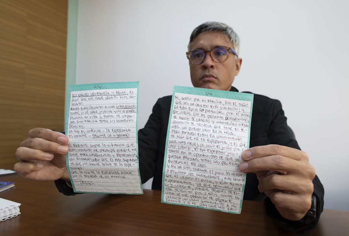 Jesus Loreto shows a letter written by Tomeu Vadell, one of six U.S. oil executives jailed for three years in Venezuela