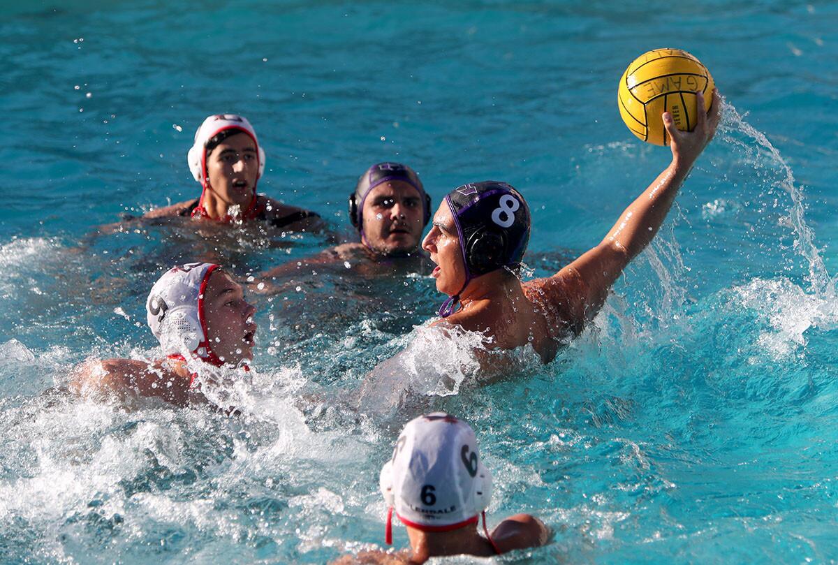 Surrounded by defenders, Hoover High School boys water polo player #8 Ven Noubarentz takes a shot on goal in home game vs. Glendale High School, in Glendale on Wednesday, Oct. 17, 2018. Hoover won 20-6.