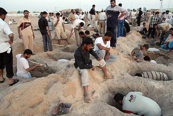 Men dig graves in the Shiite holy city of Najaf for the victims of a wave of attacks that killed 58 people. Five car bombs, including three during Friday prayers at Shiite mosques in Baghdad, killed at least 52 people days after the government said the militant group Al Qaeda in Iraq was on the run.