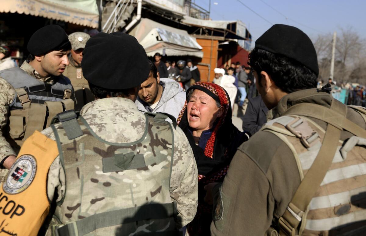 A woman cries in the aftermath of a suicide bombing at a National Civil Order Police compound in Kabul, Afghanistan, on Feb. 1.