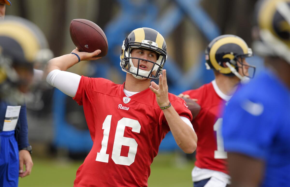 Former Cal Golden Bear and current Los Angeles Rams quarterback Jared Goff, left, passes the ball during practice, Tuesday, June 14, 2016, in Oxnard, Calif.