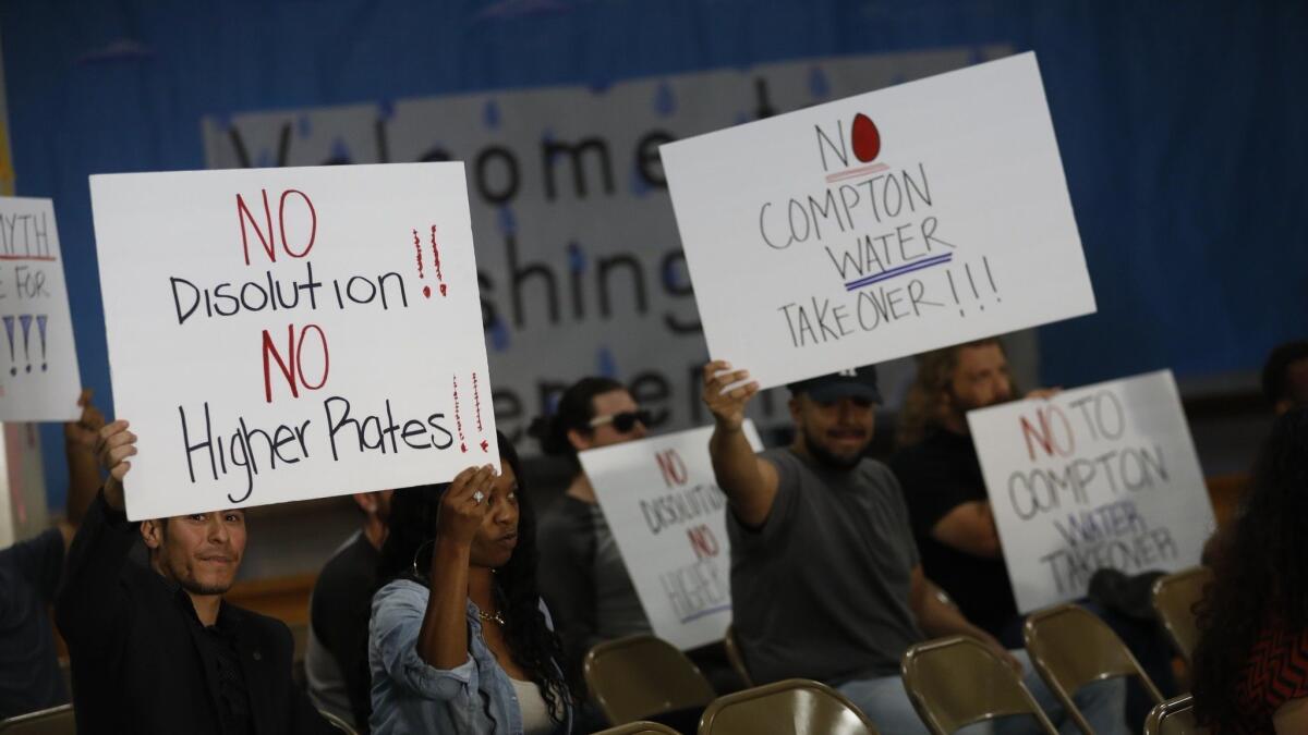 Attendees show their support for the water district at a June town hall meeting.