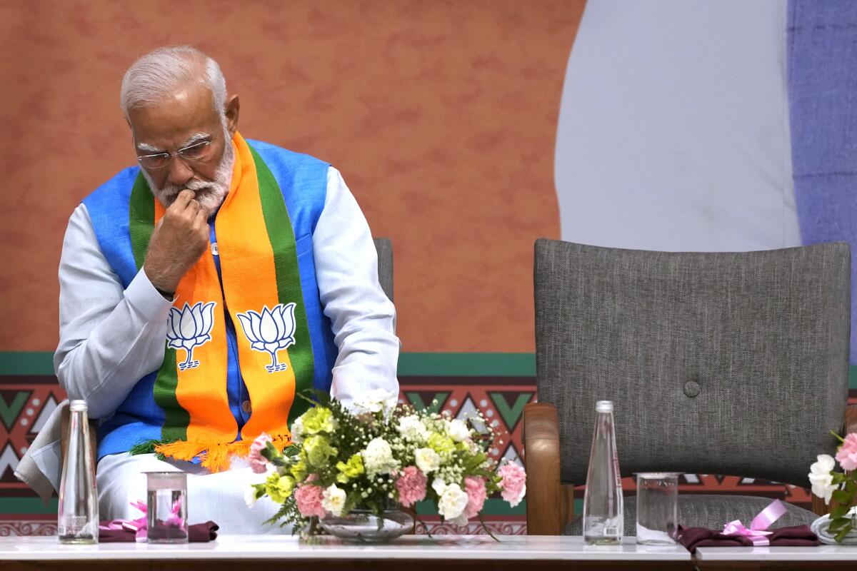 Indian Prime Minister Narendra Modi sits and looks pensive.