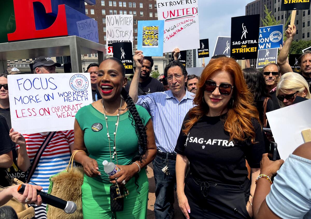 Actors Sheryl Lee Ralph, left, and Lisa Ann Walter, members of the cast of "Abbott Elementary," participate in a rally.