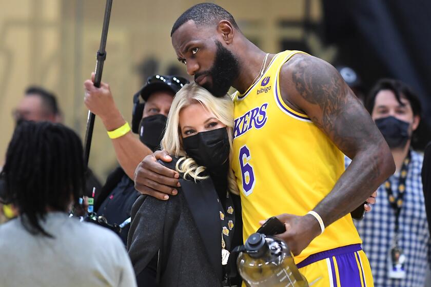 El Segundo, CA. September 28, 2021: Lakers LeBron James hugs owner Jeannie Buss during media day at the UCLA Health Training Center in El Segundo Tuesday. (Wally Skalij/Los Angeles Times)