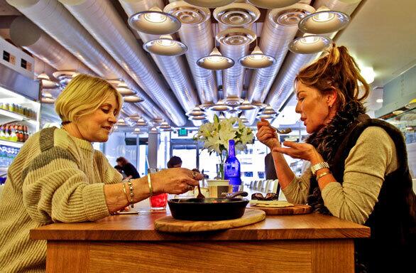 Sue Silbert, left, and Kimber Lim dine at Momed, which uses organic and sustainable ingredients.