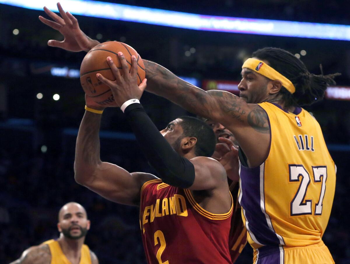 Lakers center Jordan Hill, who scored 20 points on 10-of-14 shooting, tries to block a shot by Cavaliers point guard Kyrie Irving on Thursday night.