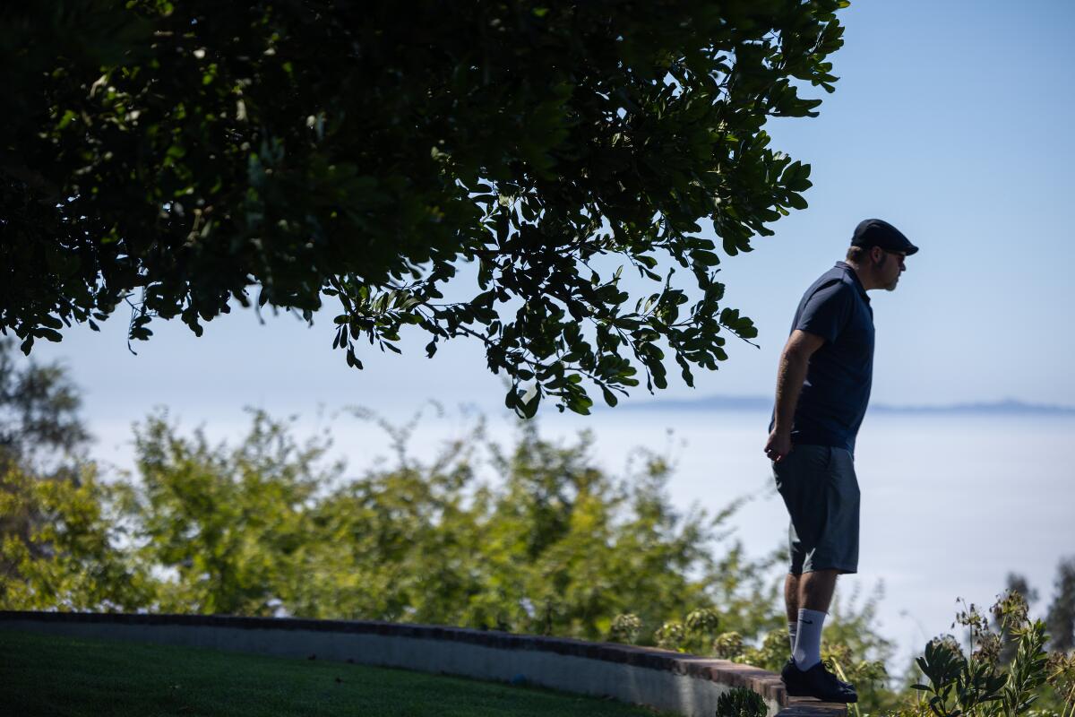 James Bellis looks out over the Portuguese Bend landslide area from his Rolling Hills home.