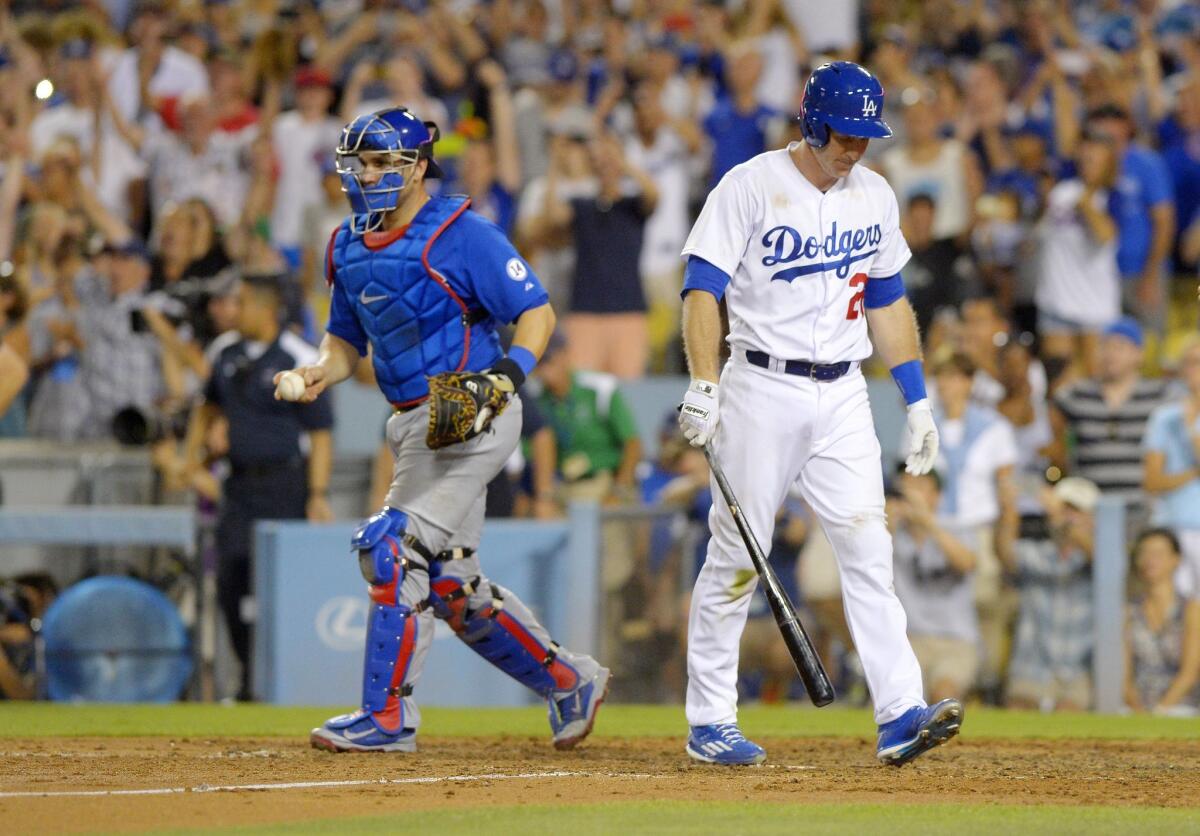 Chicago Cubs catcher Miguel Montero, left, runs toward starting pitcher Jake Arrieta as Los Angeles Dodgers' Chase Utley walks away after Arrieta completed a no-hitter in a baseball game, Sunday, Aug. 30, 2015, in Los Angeles. The Cubs won 2-0. (AP Photo/Mark J. Terrill)