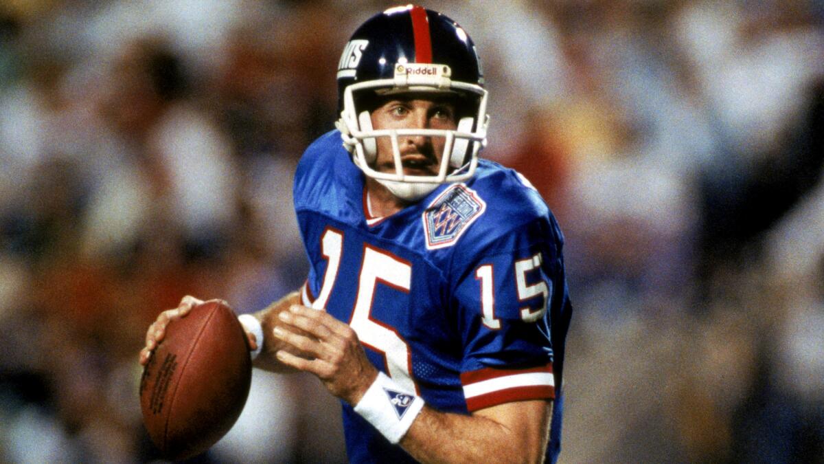 Giants quarterback Jeff Hostetler rolls out against the Bills during Super Bowl XXV at Tampa Stadium on Jan. 27, 1991.