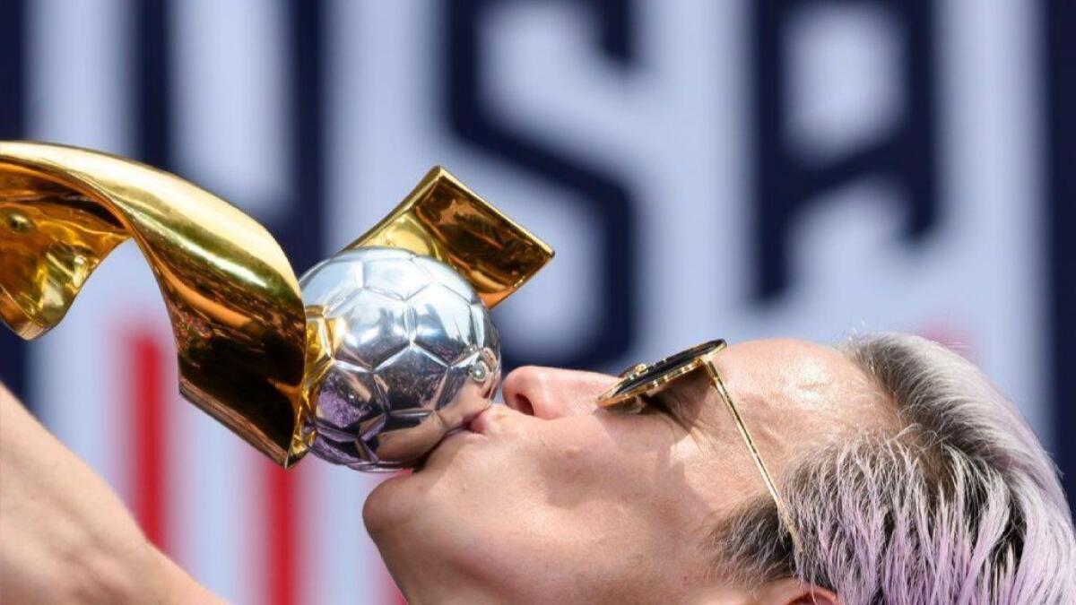 U.S. women's soccer player Megan Rapinoe kisses the World Cup trophy in New York after a ticker tape parade on July 10.