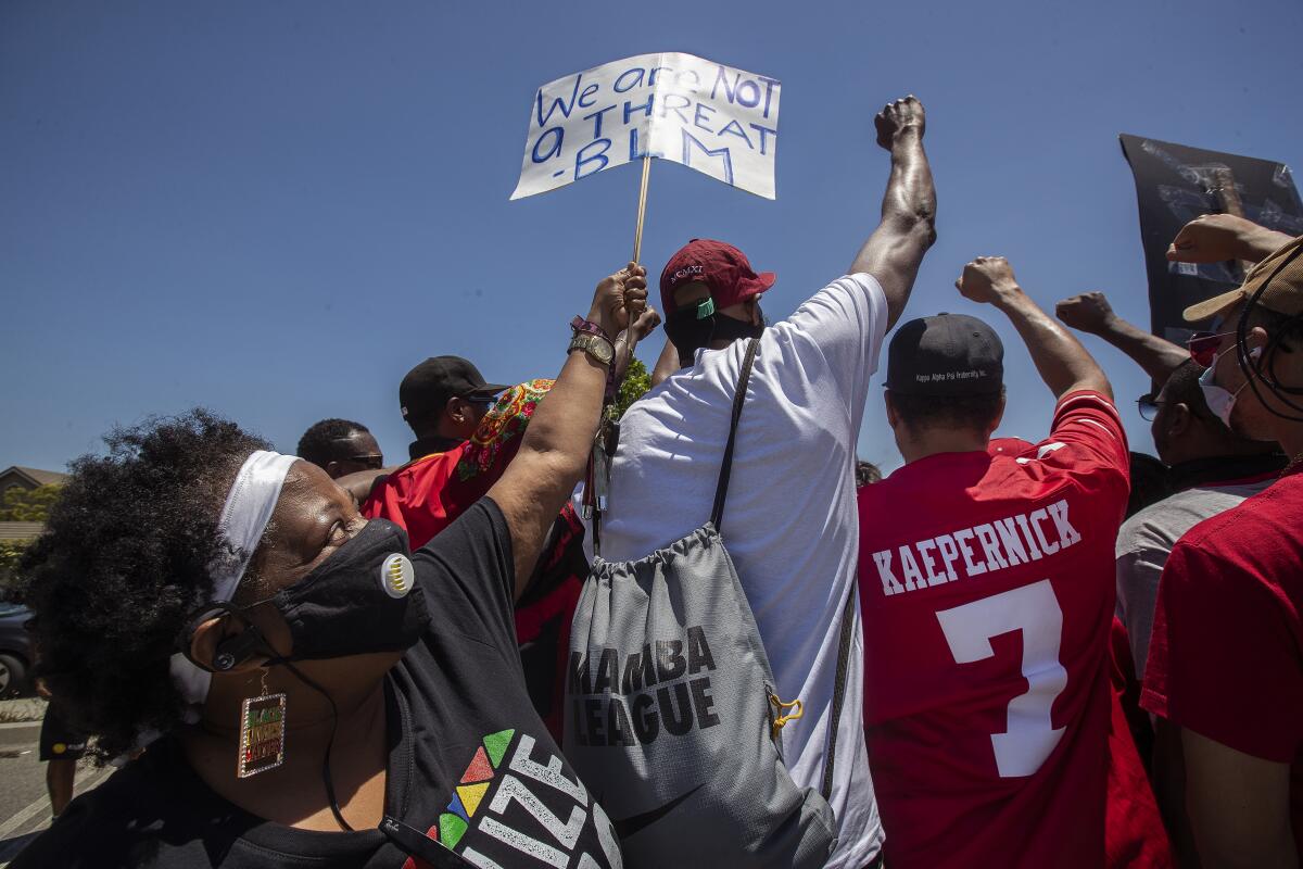 Penny Miller joins other protesters in the Forum parking lot in Inglewood.