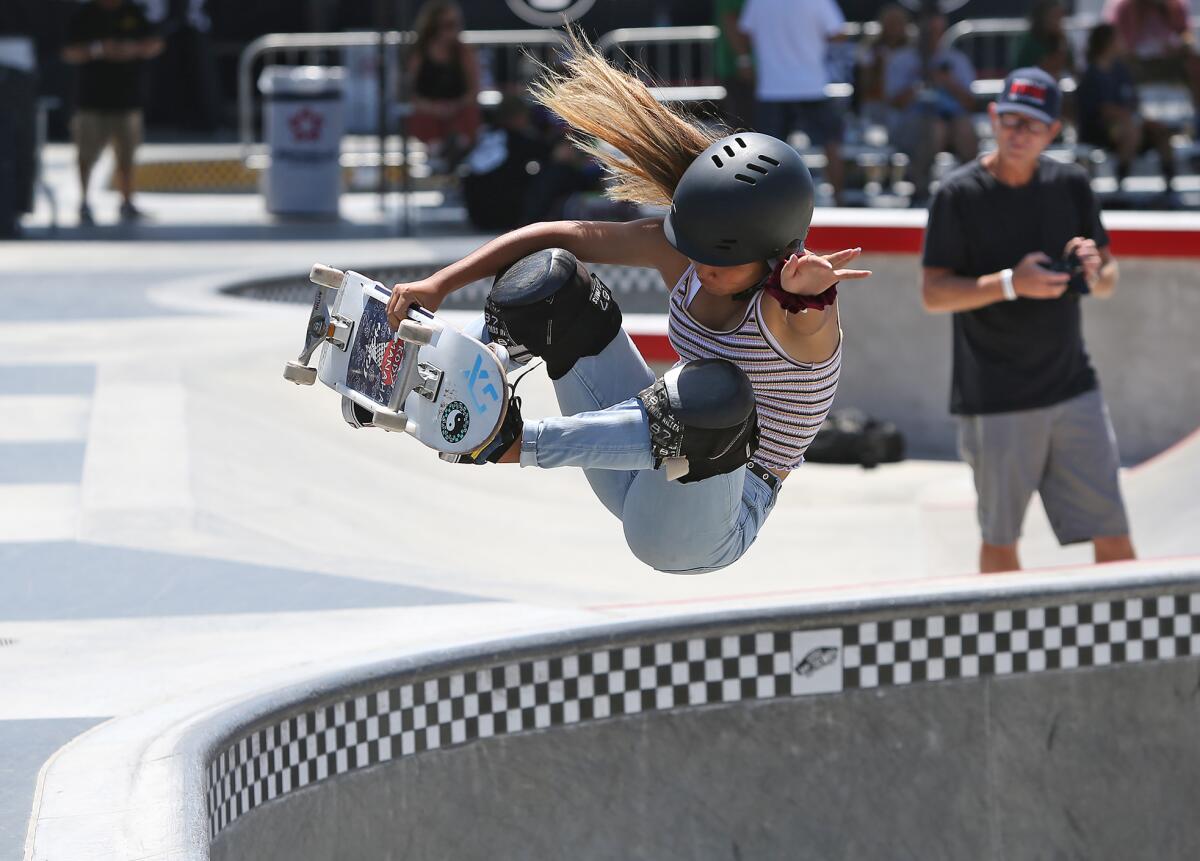 Eventual winner Kody Tamanaha flies high as she performs a front-side rail grab in the women's competition of the 2019 Vans Park Series Americas Regional Championships on Friday at Vans Off the Wall Skatepark in Huntington Beach.