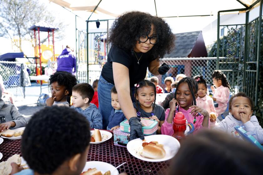 LOS ANGELES-CA-FEBUARY 12, 2024: Ian Harris, who has worked at From the Heart Preschool in Los Angeles for one year, serves lunch to the children on February 12, 2024. (Christina House / Los Angeles Times)