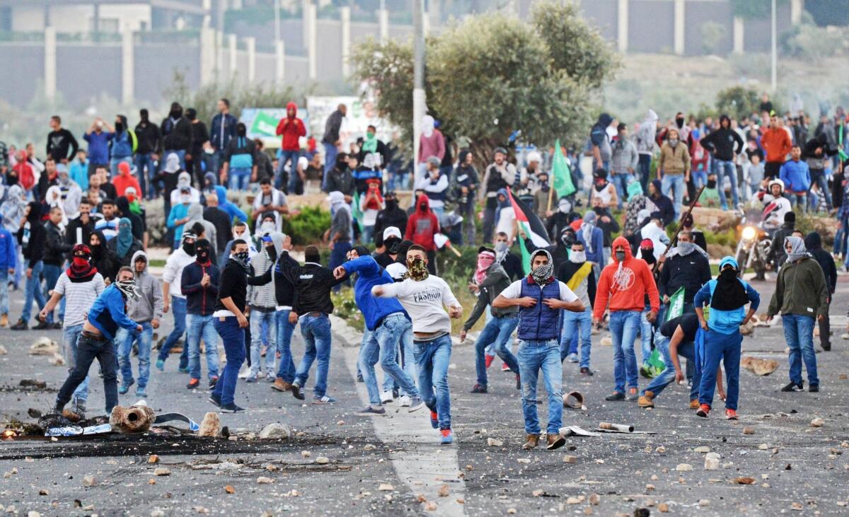 Israeli Arabs throw rocks at Israeli police during clashes over the shooting of a 22-year-old Arab man in the northern central town of Kafr Kanna, near Nazareth, Israel on Nov. 8.