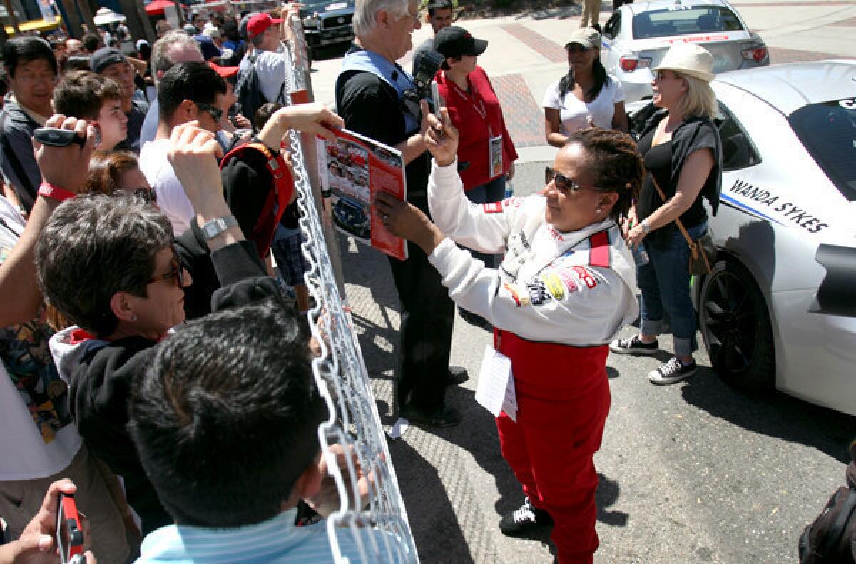 LONG BEACH, CA. --APRIL 19, 2013: Comedian Wanda Sykes signs autographs after racing in the Toyota Pro/Celebrity event on Saturday in Long Beach.