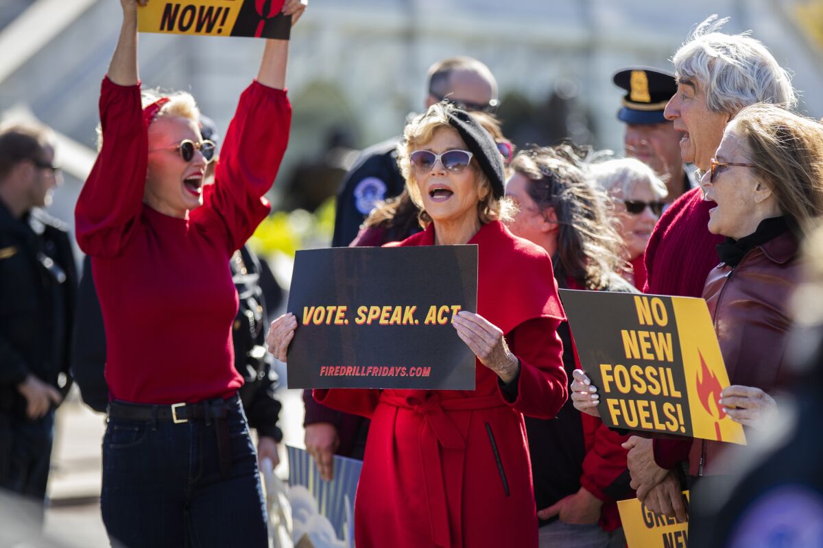 Jane Fonda, center, and Sam Waterston, right, during a rally on Capitol Hill in Washington on Friday.