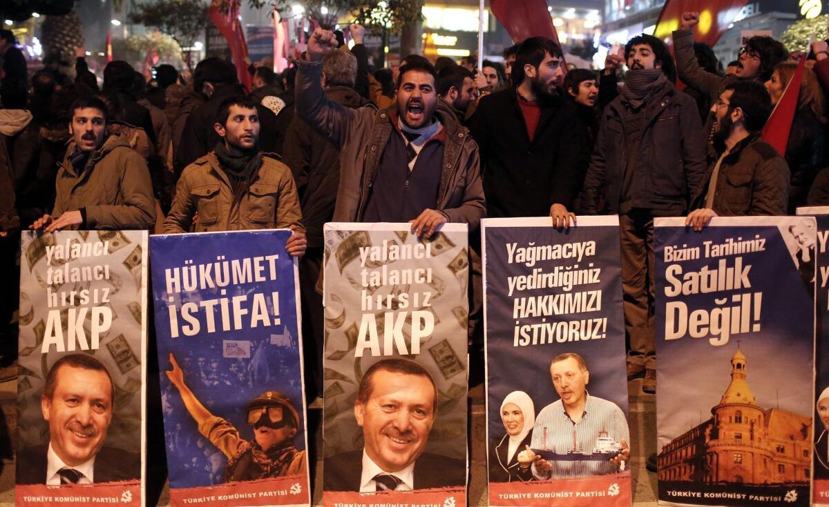 Turkish protesters shout slogans against the government as they hold banners reading "Government resign," and "Liar, looter, robber AKP" (referring to the Justice and Development Party), during a demonstration in Istanbul on Wednesday.