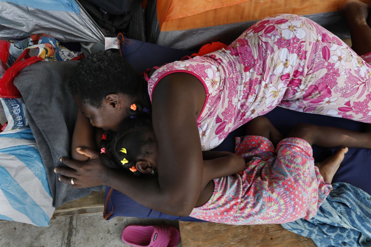 A mother and daughter from the Democratic Republic of Congo rest in a refugee camp in Acuña. The family of five is hoping for asylum in the U.S.