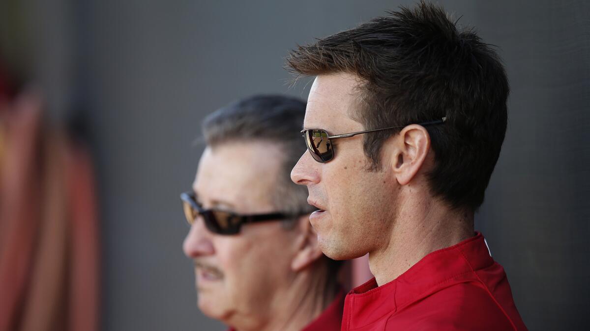 Angels owner Arte Moreno, left, and General Manager Jerry Dipoto observe a spring training practice session in February. The Angels aren't expected to make major player moves before Thursday's trade deadline.