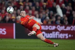 FILE - Wales' Gareth Bale takes a shot during the World Cup 2022 playoff soccer match between Wales and Austria.