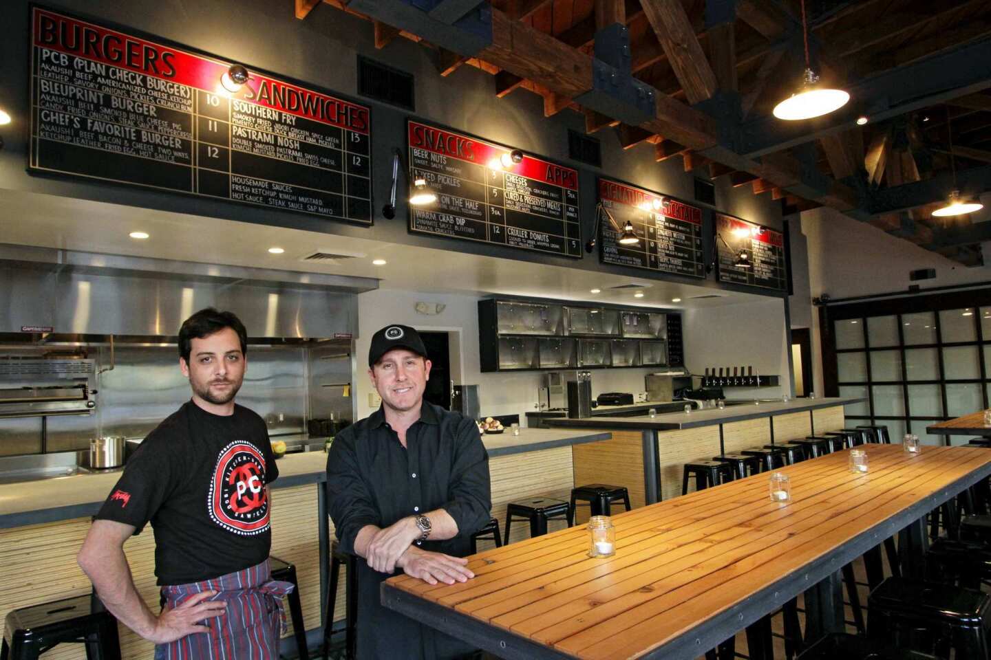 Co-owners chef Ernesto Uchimura, left, and Terry Heller inside their restaurant, Plan Check Kitchen + Bar.