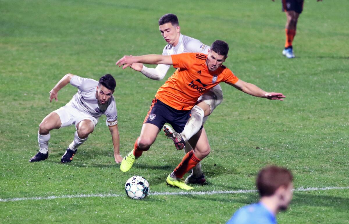 Orange County Soccer Club's Dillon Powers dribbles around defenders against San Antonio FC in the Western Conference finals.