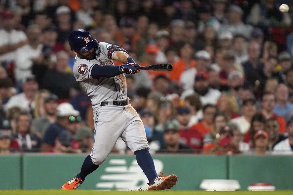 Houston's Jose Altuve hits a two-run triple in the sixth inning against the Boston Red Sox at Fenway Park.