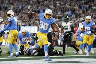 Austin Ekeler (30) spikes the football and running for a Chargers touchdown against the Jets.