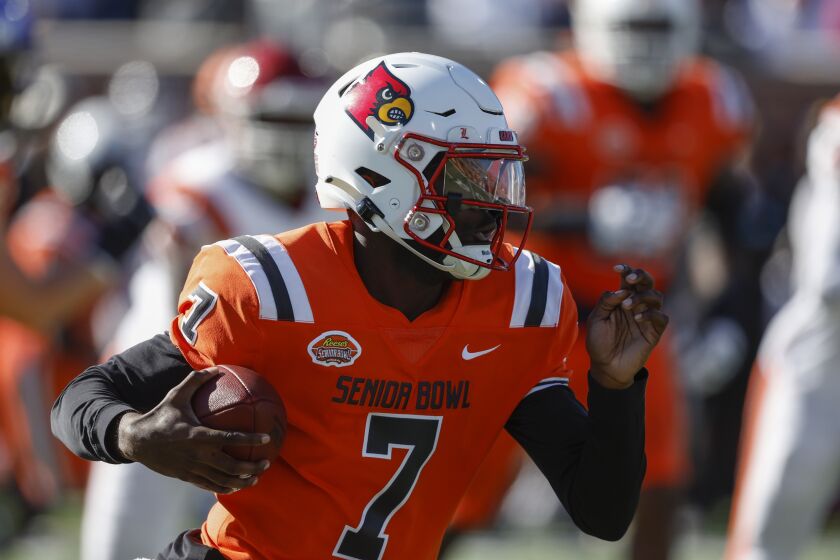 National quarterback Malik Cunningham, of Louisville, carries the ball during the first half of the Senior Bowl NCAA college football game, Saturday, Feb. 4, 2023, in Mobile, Ala.. (AP Photo/Butch Dill)