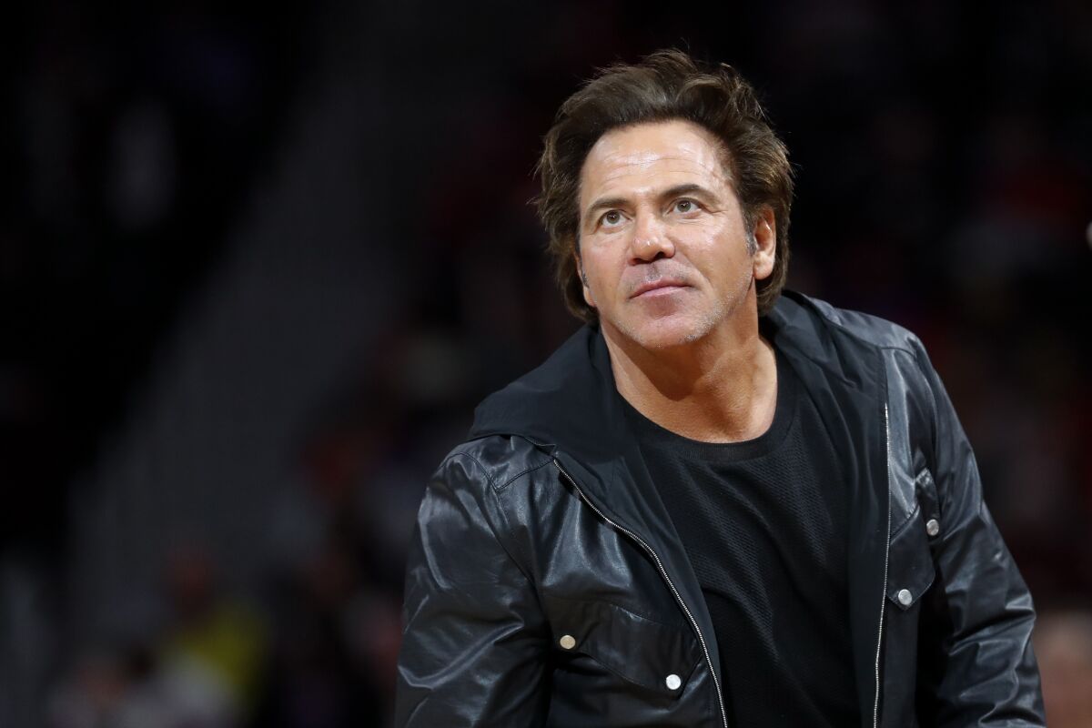 Detroit Pistons owner Tom Gores watches an NBA basketball game.