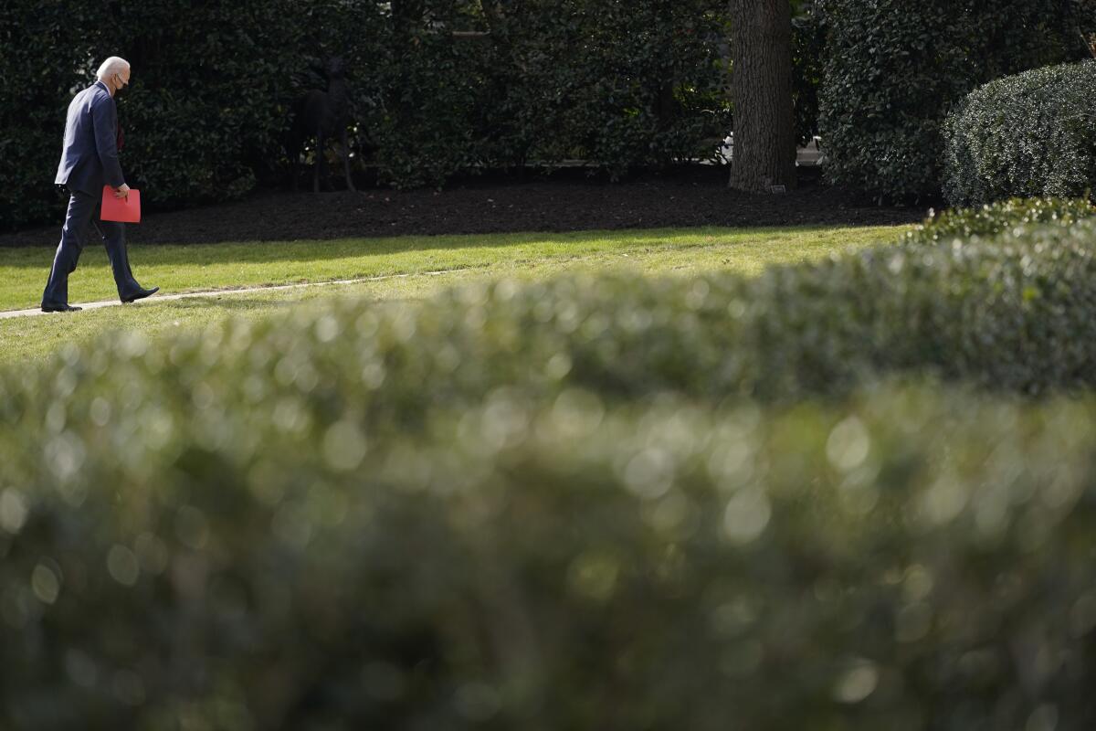 President Joe Biden walks back to the White House. 